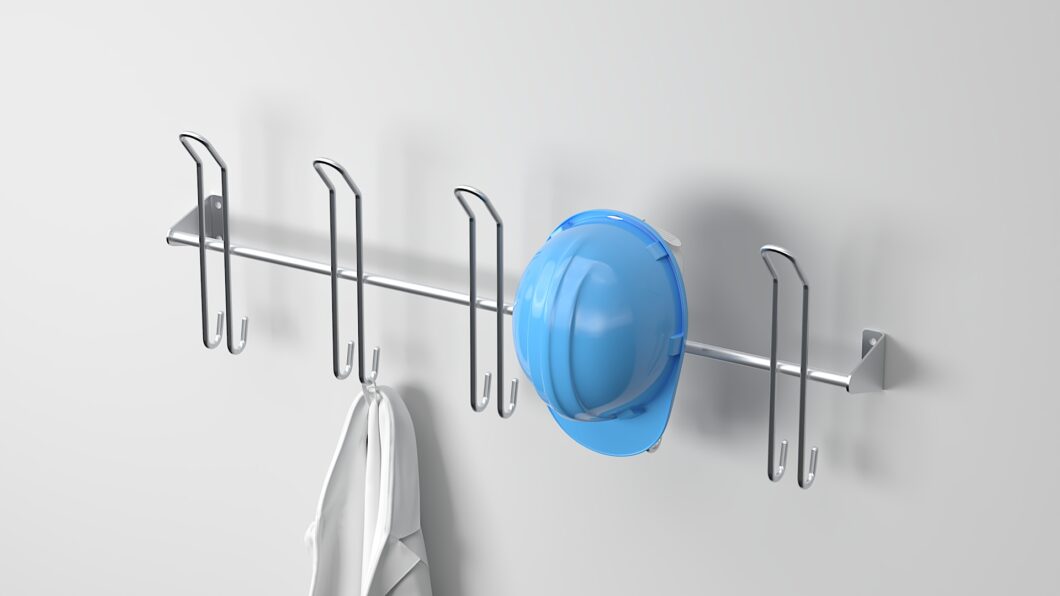 Stainless steel helmet rack with five double hooks, holding a blue safety helmet and a jacket, ideal for work gear storage.